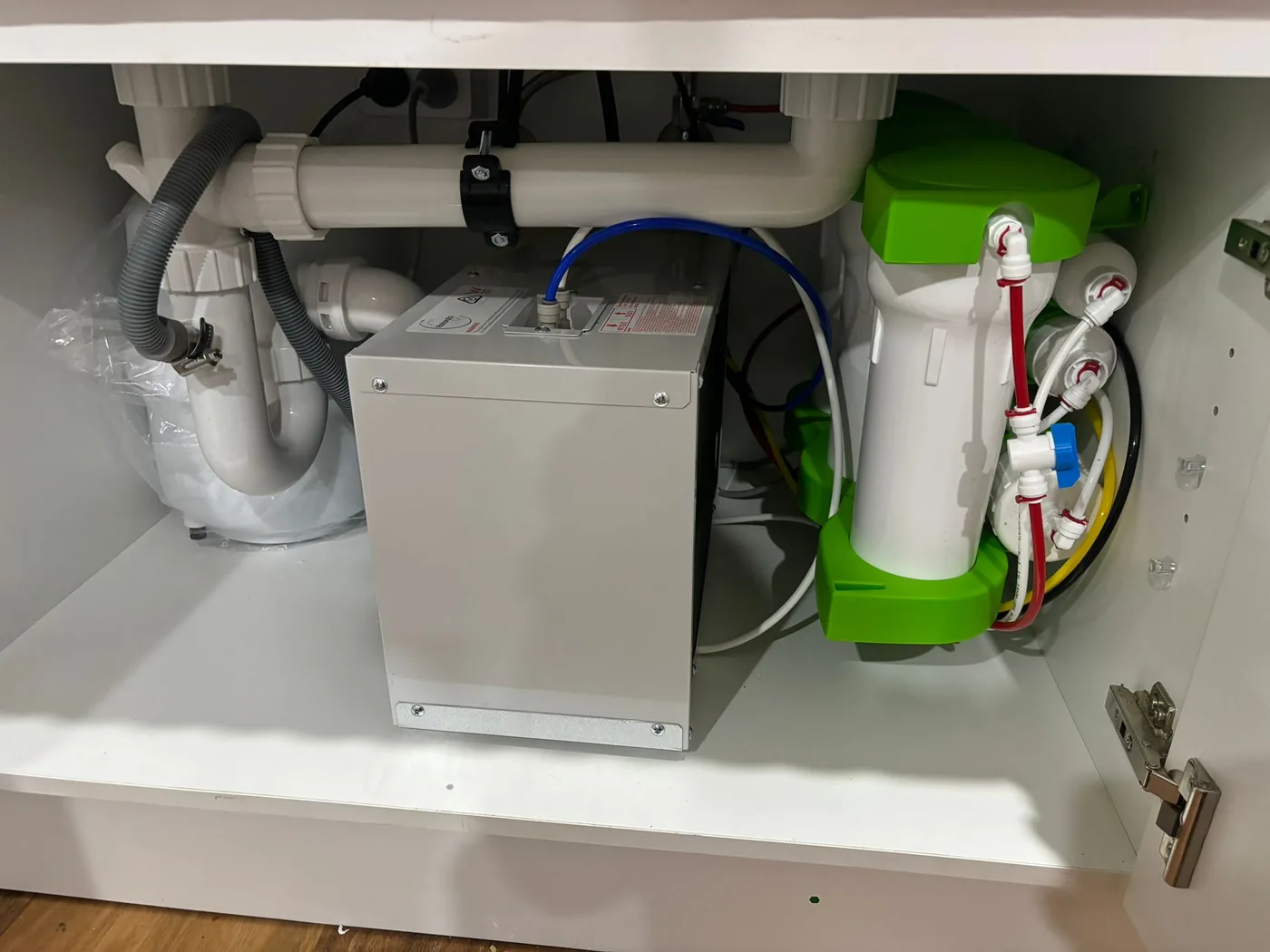 Under-sink water chiller and filter system installed in a kitchen cabinet